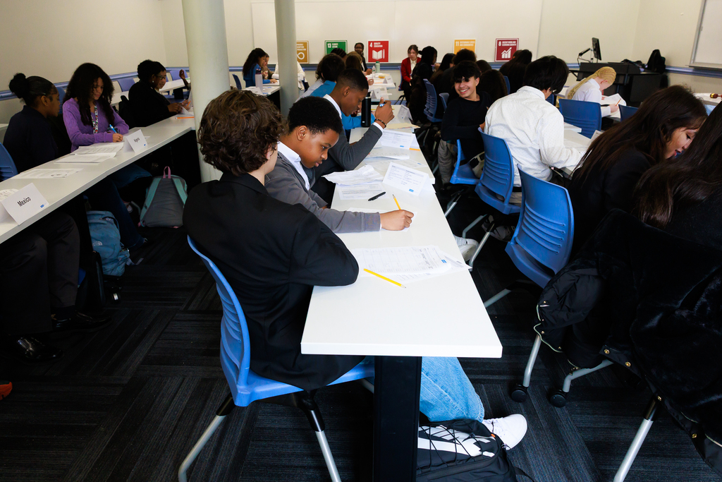 Students take notes during a Model UN simulation.