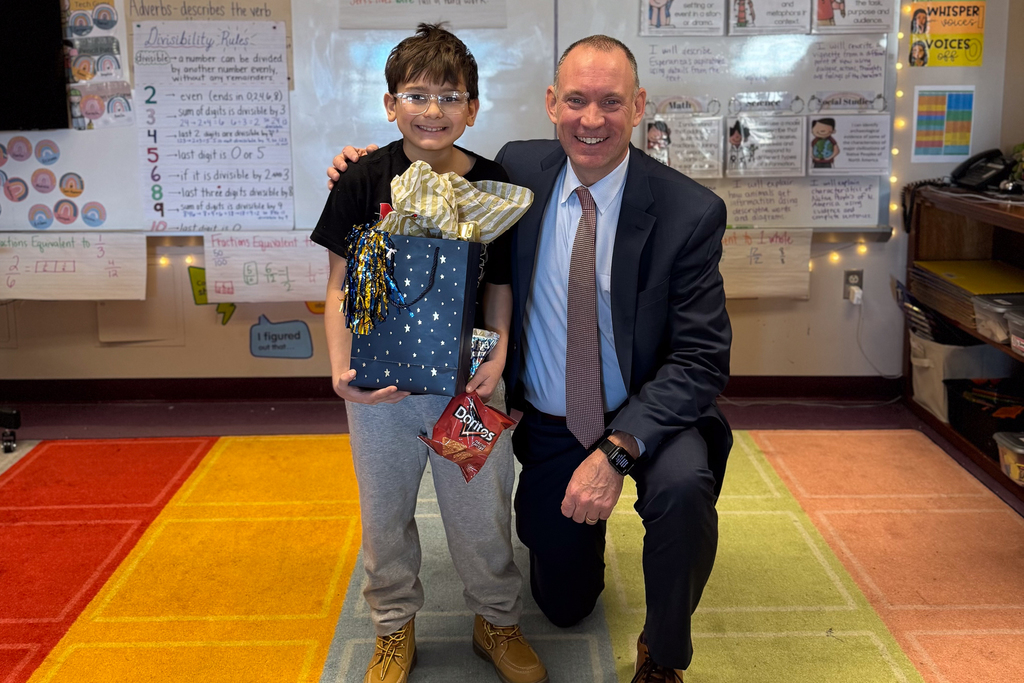 Superintendent Allen stands with Quinsigamond School fourth grader Januel Rivera.
