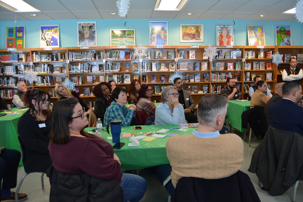 Adults sitting in a meeting room during a discussion