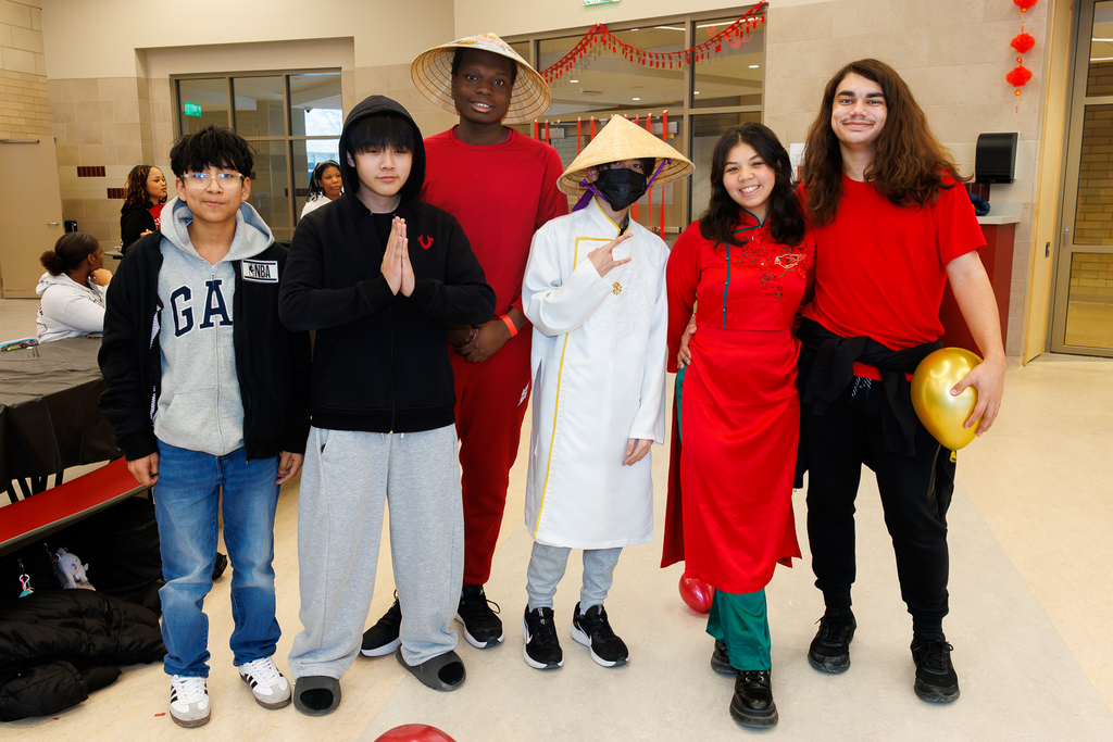 Six students stand side-by-side smiling for a photo.