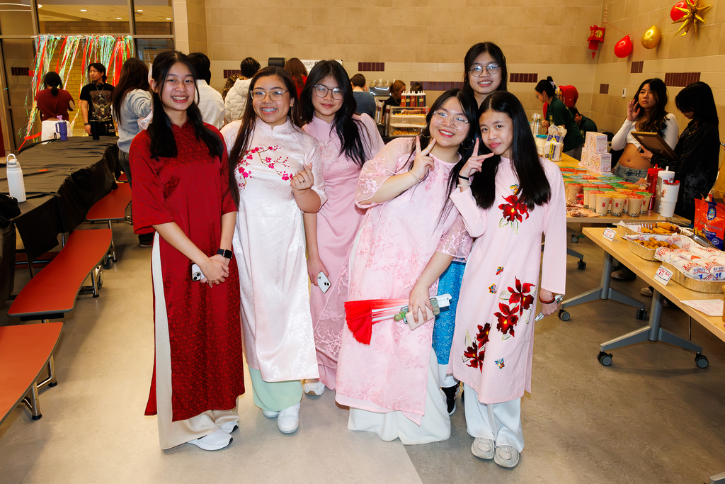 Six students in traditional clothing pose for a photo. 