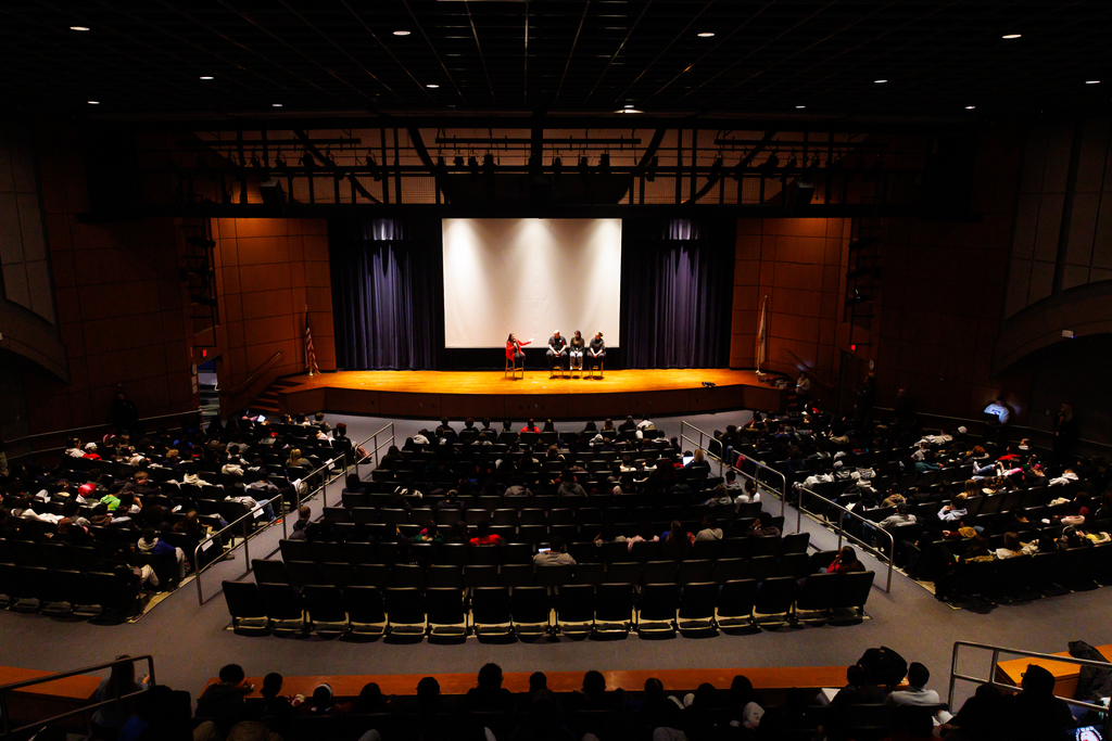 An auditorium of students during a Q/A session.