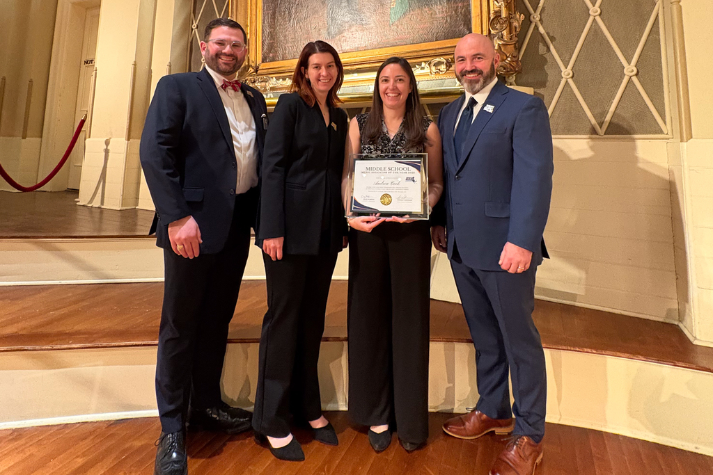 Andrea Cook accepts the 2026 Central Massachusetts Middle School Music Educator Award, alongside officials from Central District Massachusetts Music Educators Association.