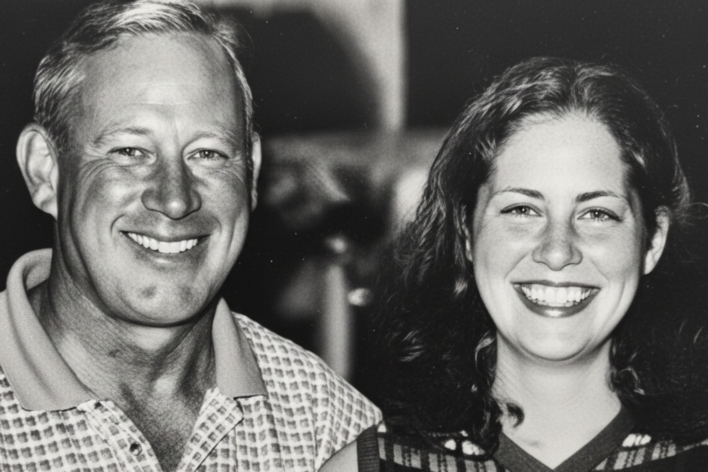A black and white portrait of a smiling man and woman.