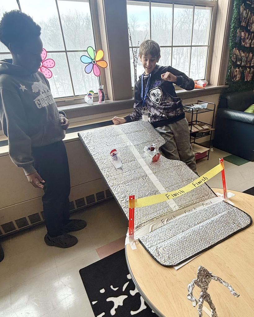 Two students participate in a science experiment. 