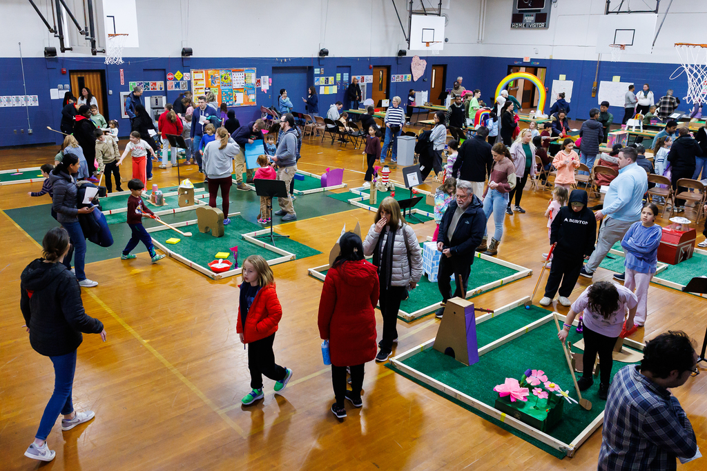 A full view of the busy gym during a mini-golf event at Worcester Arts Magnet School.