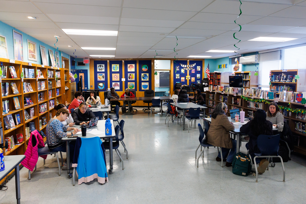 Families and staff meet in the library to discuss their financial aid award package.