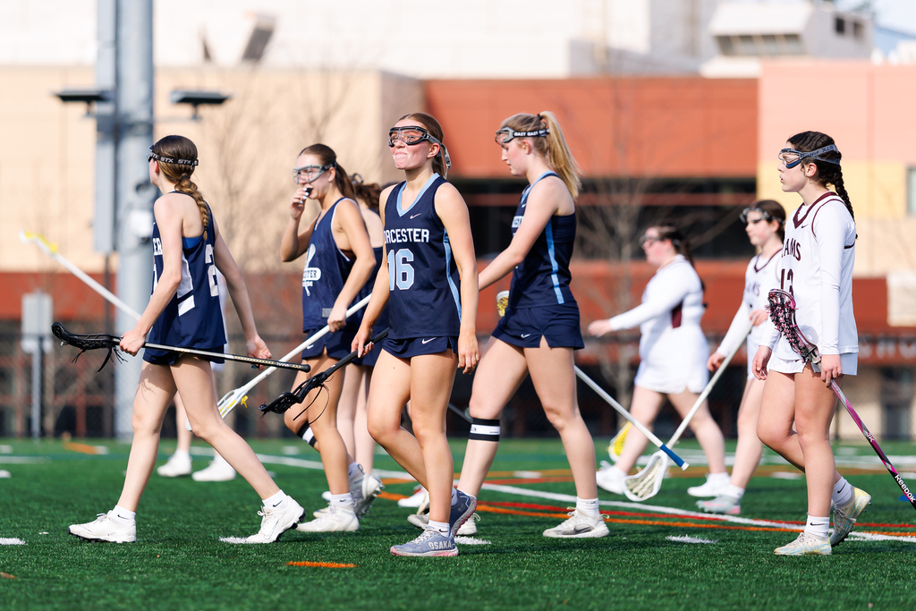 A player smiles to the sidelines after scoring a goal.