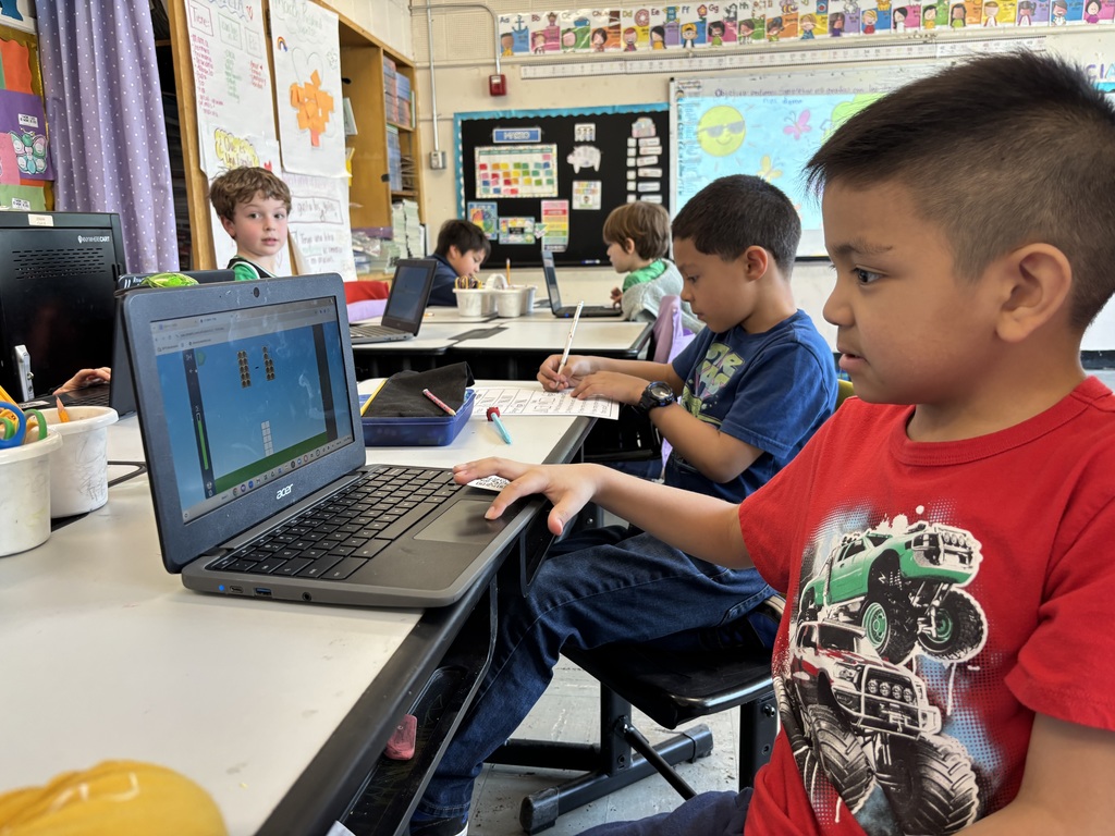 A child on a laptop computer in a classroom