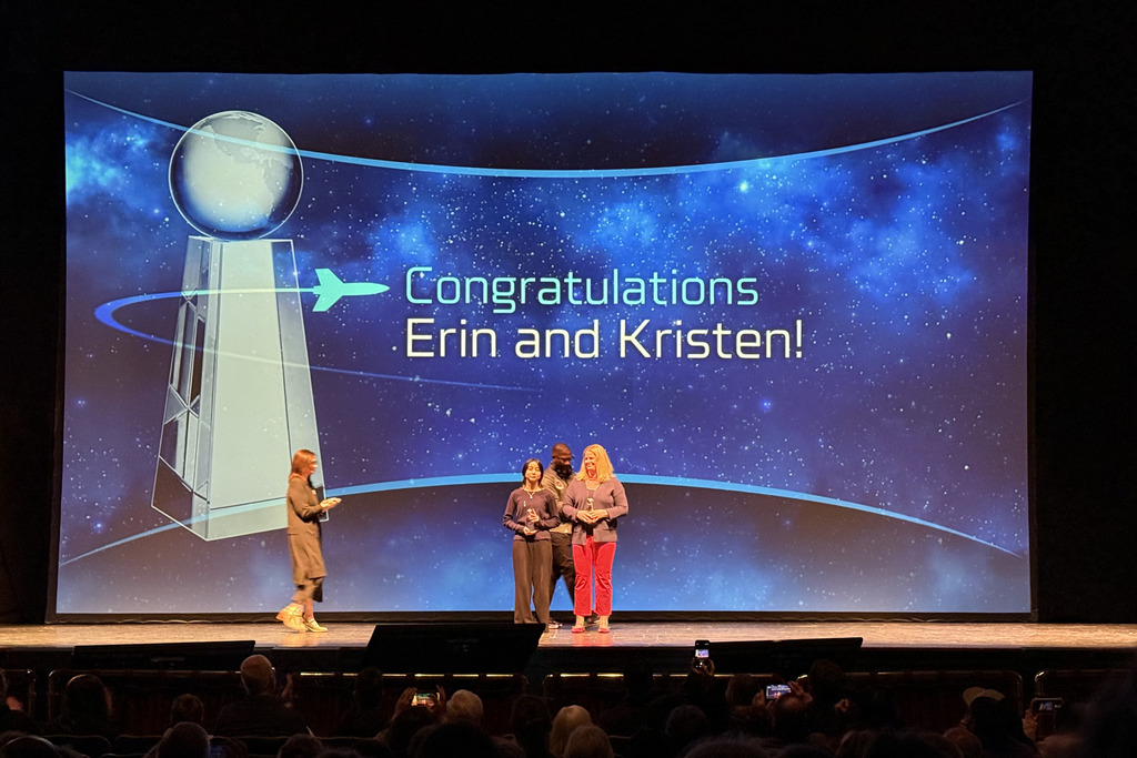 Kristen Doan and Erin Morrissey stand together on stage to accept the Esther Goddard Teacher and Student Awards respectively. 