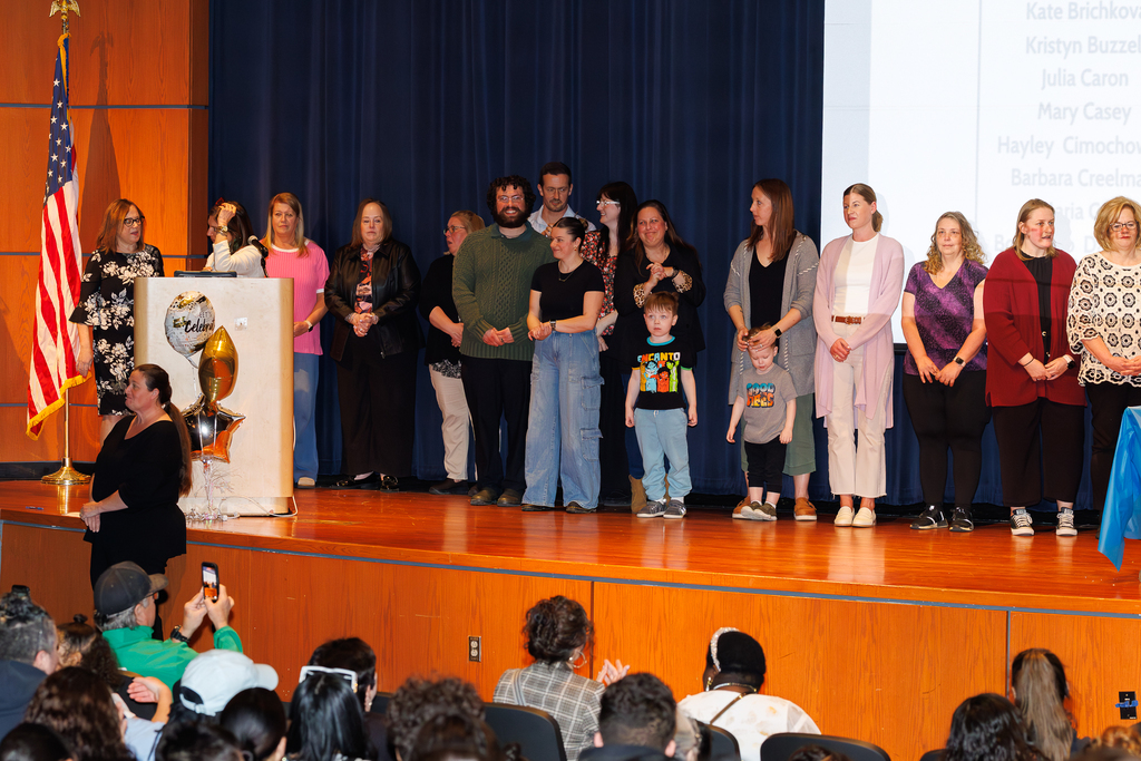 Staff members in the special education department stand together on stage in recognition.