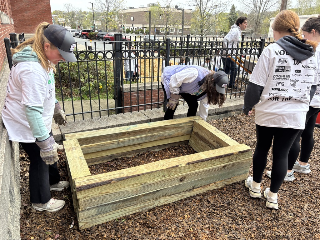 Four people installing a mulch bed