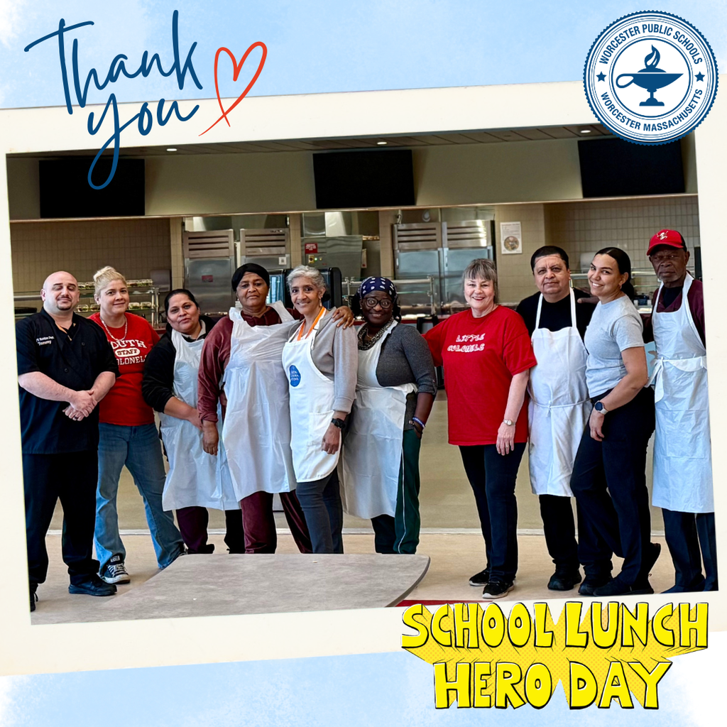 A diverse group of school lunch staff members stand together, smiling, in a school cafeteria. Text reads 'Thank you' and 'School Lunch Hero Day'.