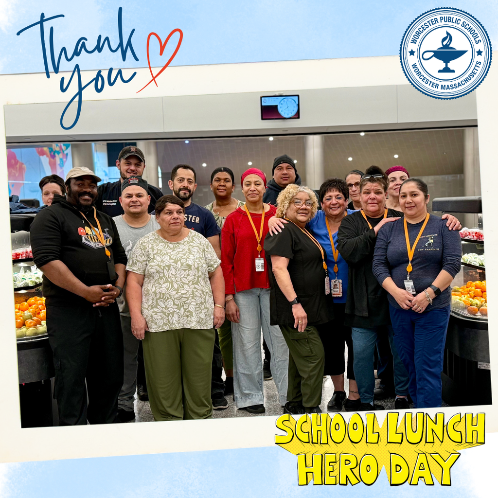 A group of school lunch staff members smile for a photo, celebrating School Lunch Hero Day.