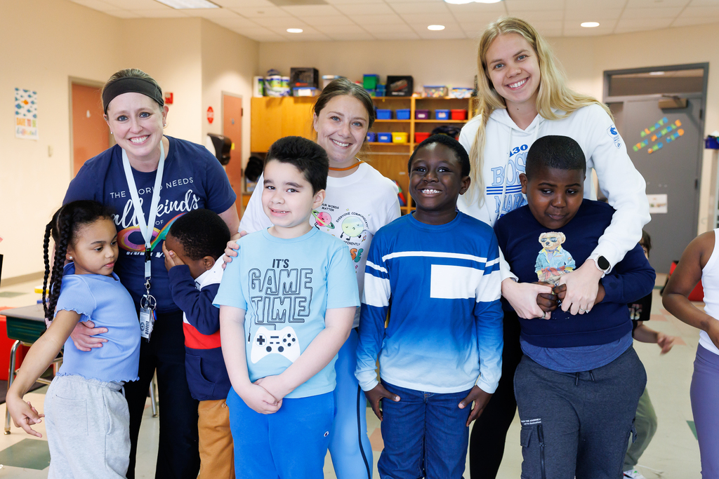 Teachers and students stand together wearing blue to close out Autism Awareness Month.