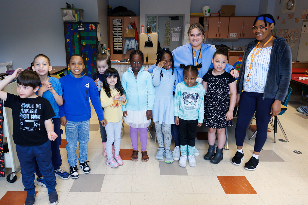 Students and teachers stand together wearing blue to close out Autism Awareness Month.