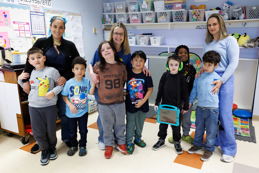 Students and teachers stand together wearing blue to close out Autism Awareness Month.