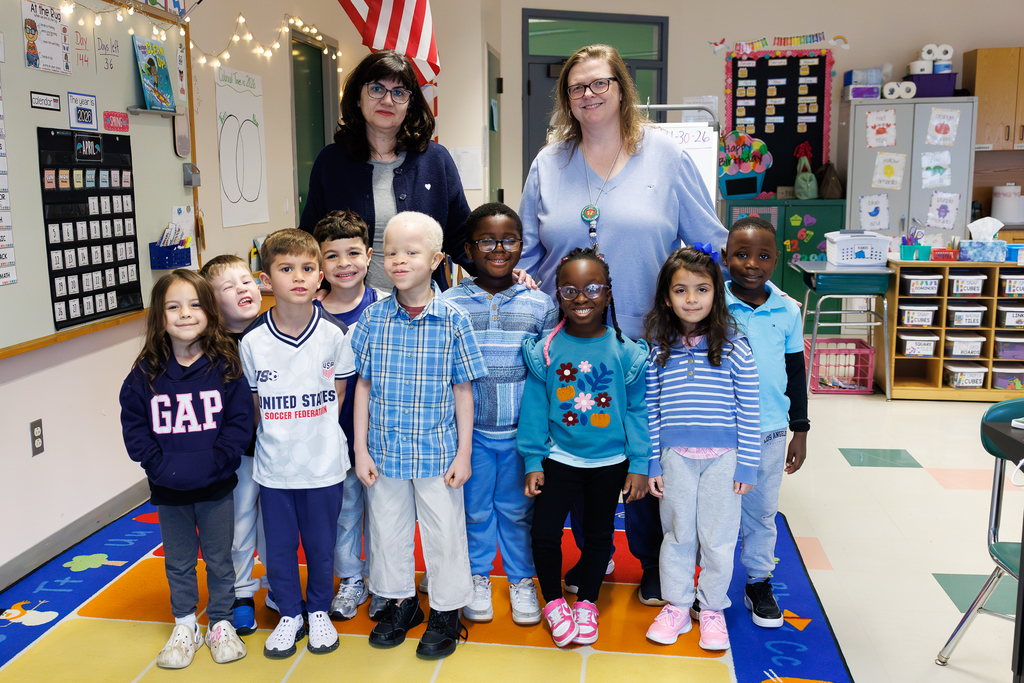 Teacher and students stand together wearing blue to close out Autism Awareness Month.