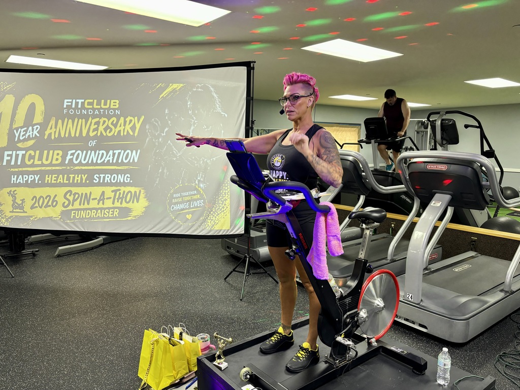 A woman standing next to a spin machine