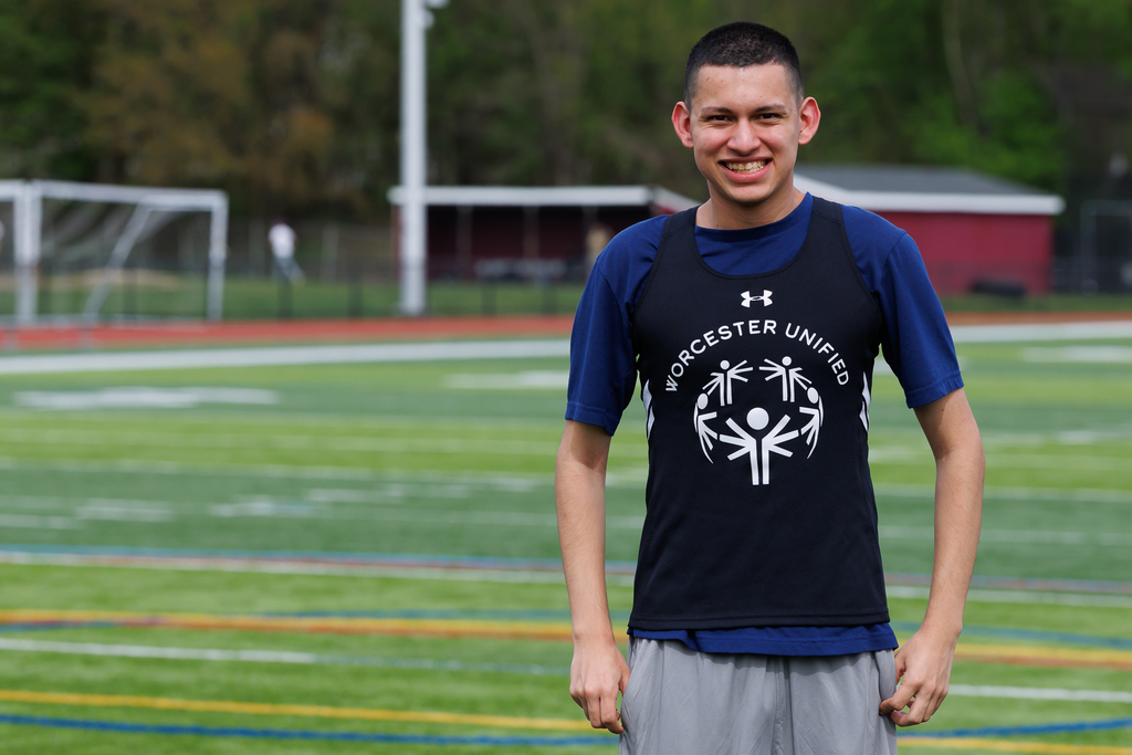 A student gives a big smile before a track and field meet.