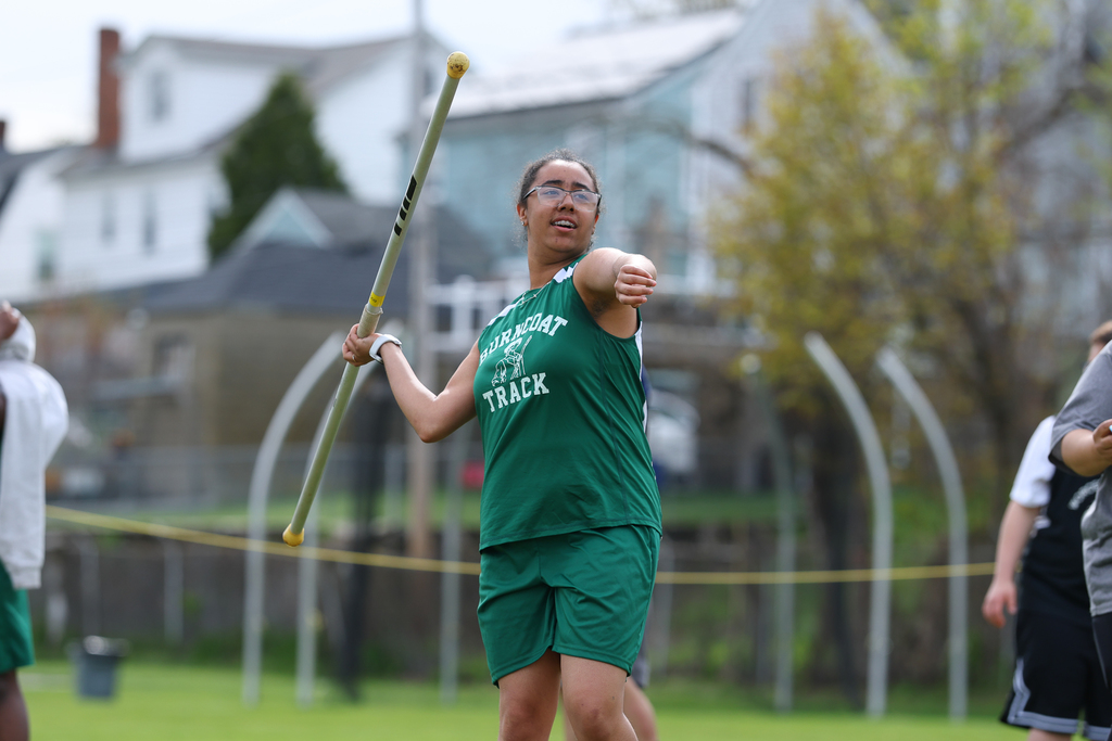 A student gets ready to throw a javelin during a track & field meet.