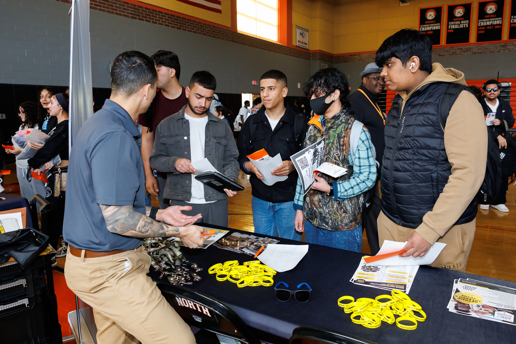 A group of students learn more about a business during a career day.