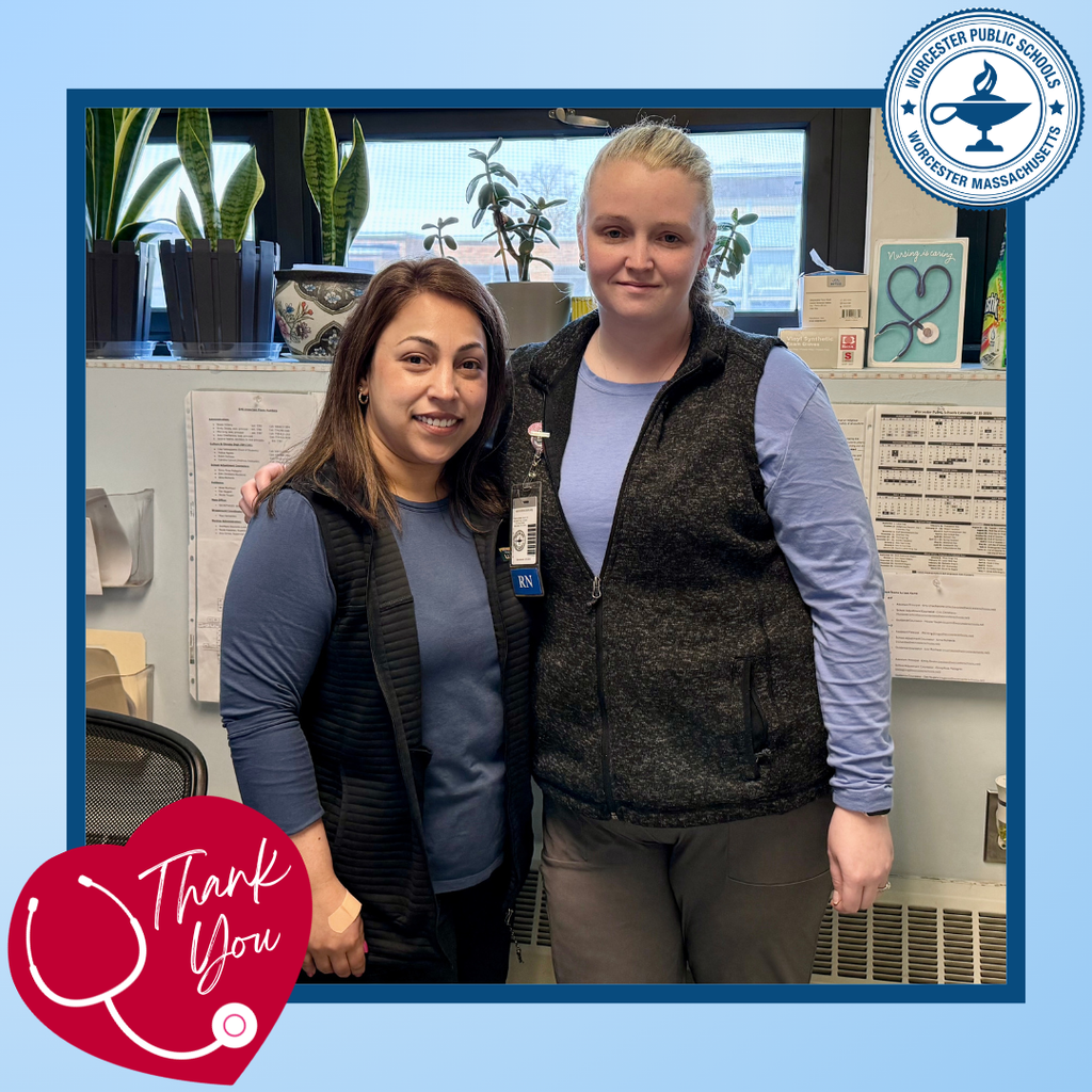 Two women, identified as RNs, smile together in a room with plants and medical charts.