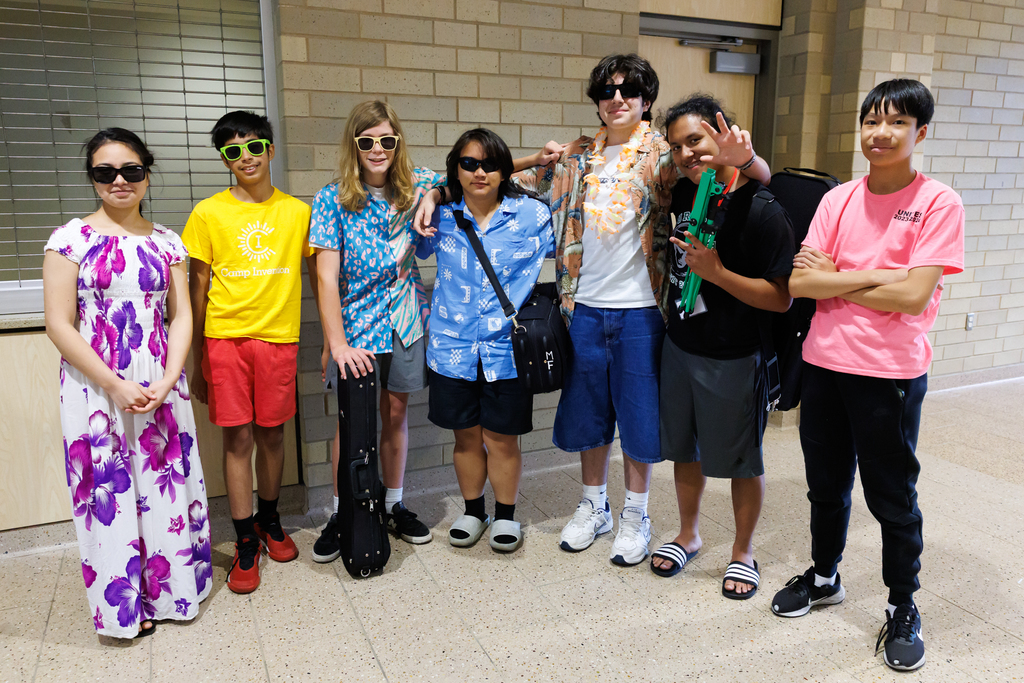 Students stand together wearing floral attire and sunglasses following the 2025 Summer UNITES concert.