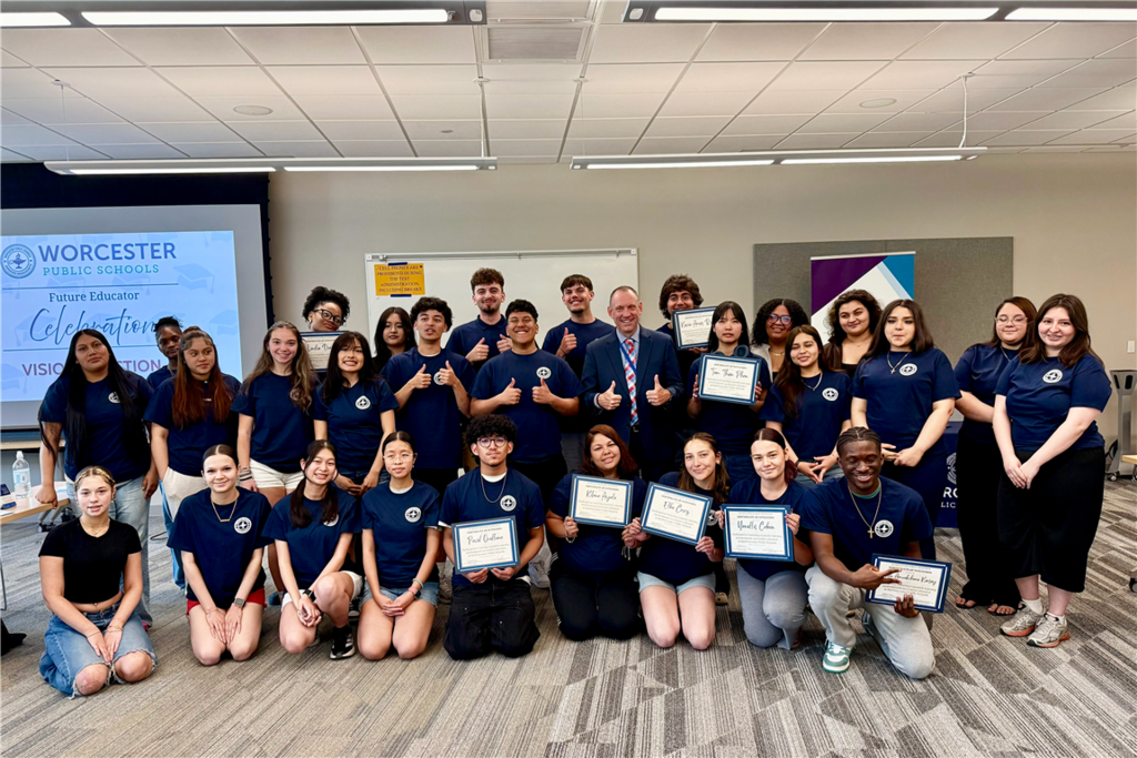 A group of students and an adult pose for a photo at a "Future Educator Celebration" event.