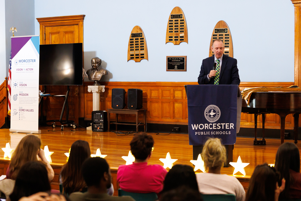 Superintendent Brian E. Allen speaks to students while on stage.