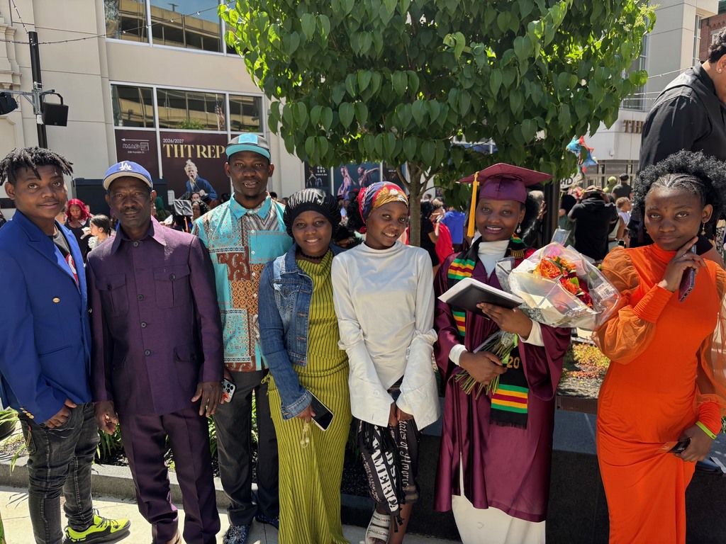 A family poses for a photo with their graduate