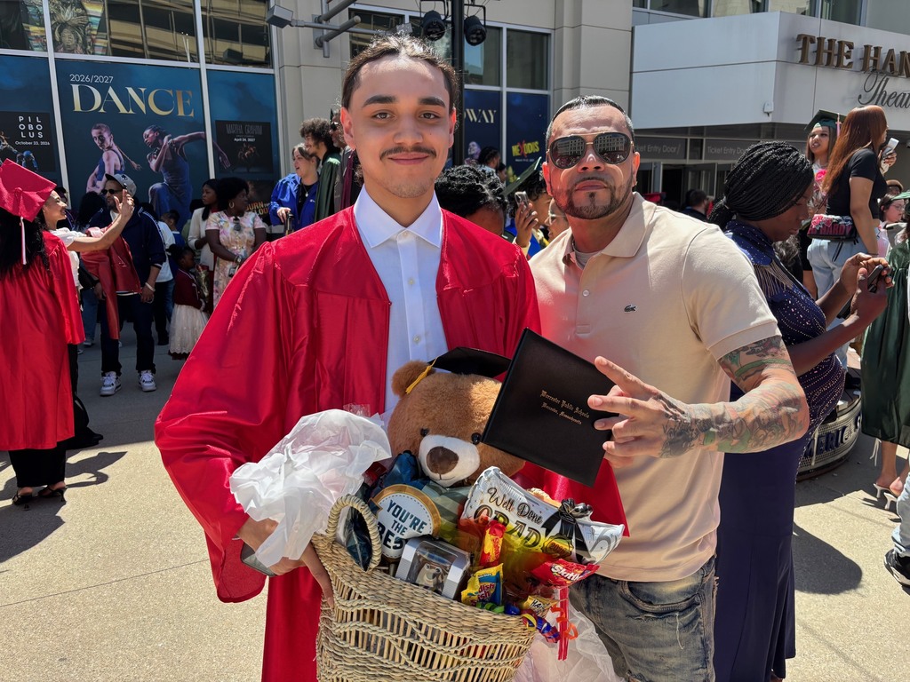 A family poses for a photo with their graduate