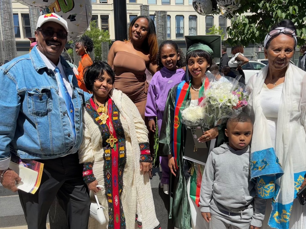 A family poses for a photo with their graduate