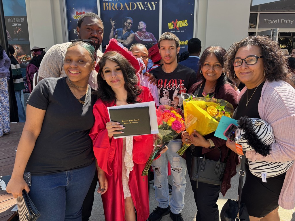 A family poses for a photo with their graduate