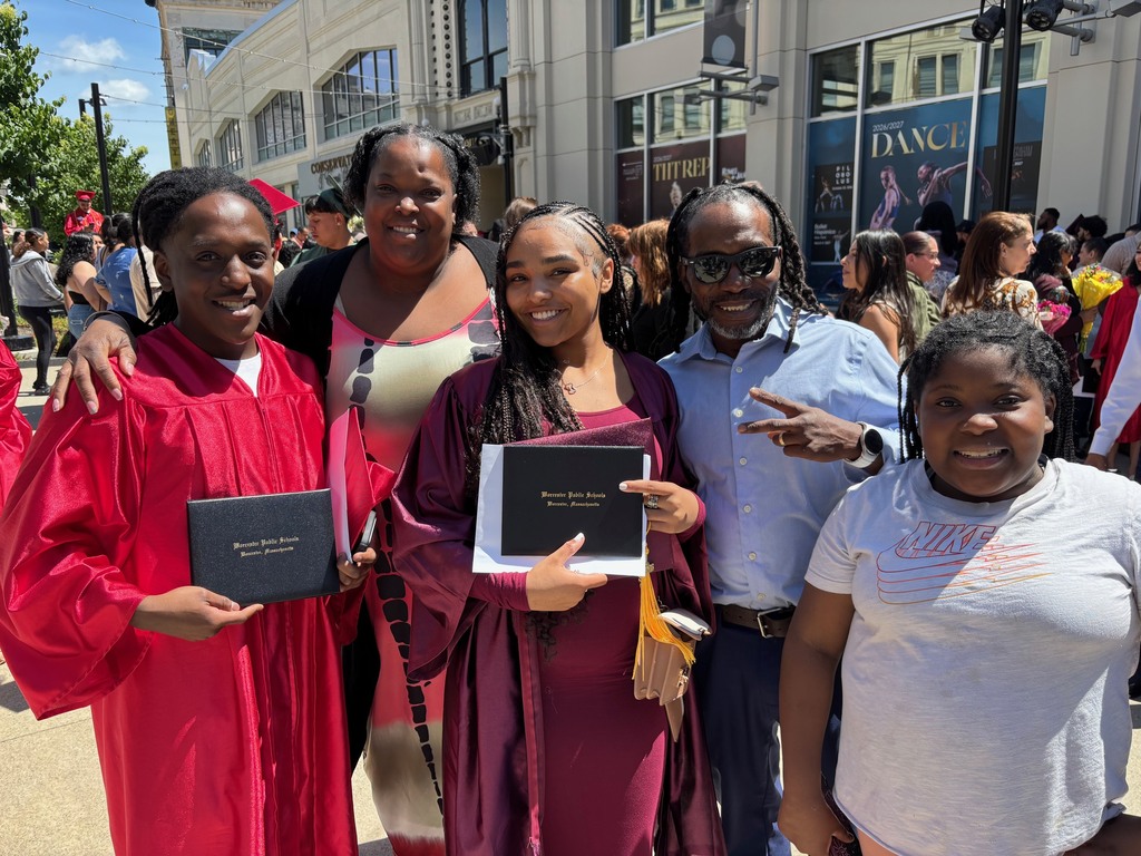 A family poses for a photo with their graduate