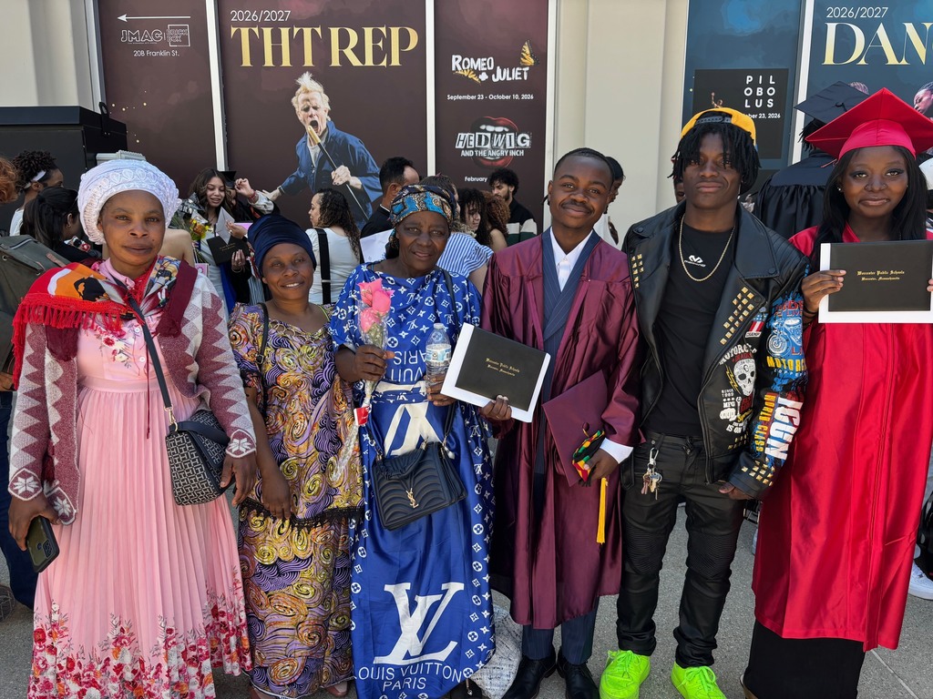 A family poses for a photo with their graduate