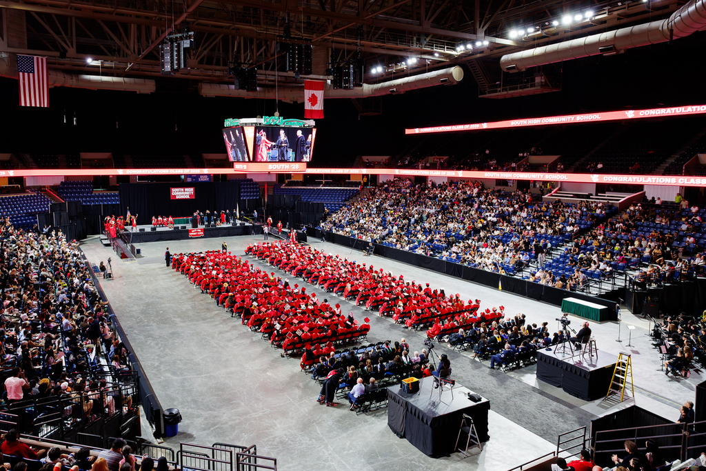 A wide-angle of the DCU Arena filled with families and students during a high school graduation.