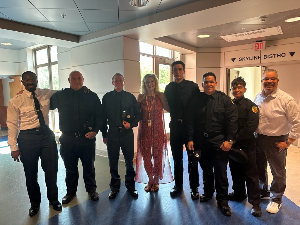 Worcester Technical High School alumni who graduated from the Worcester Firefighter Academy pose with their training officer and retired Worcester Tech Educator Rick Torres during a graduation celebration. 