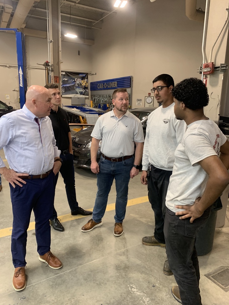 Three teachers and two students probably discussing the plans for the car renovation and sharing ideas. 