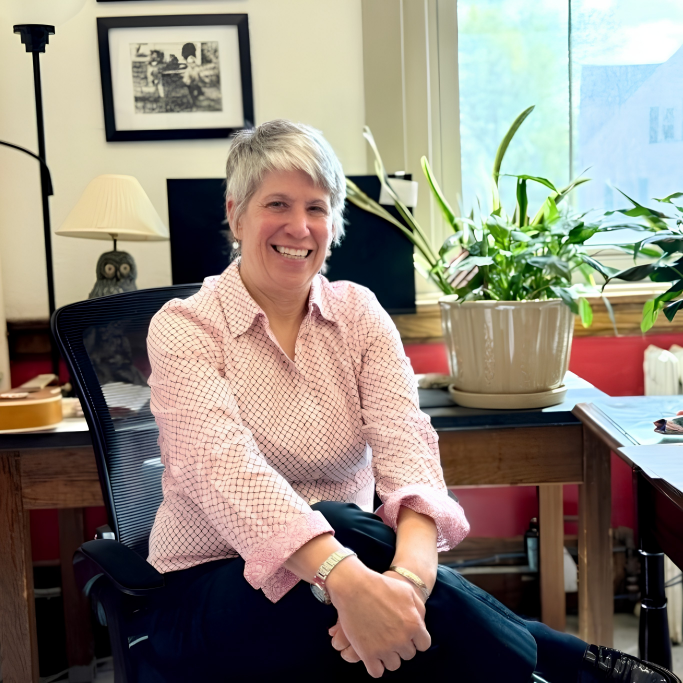 An image of Dr. Karrie Allen sitting at her desk.