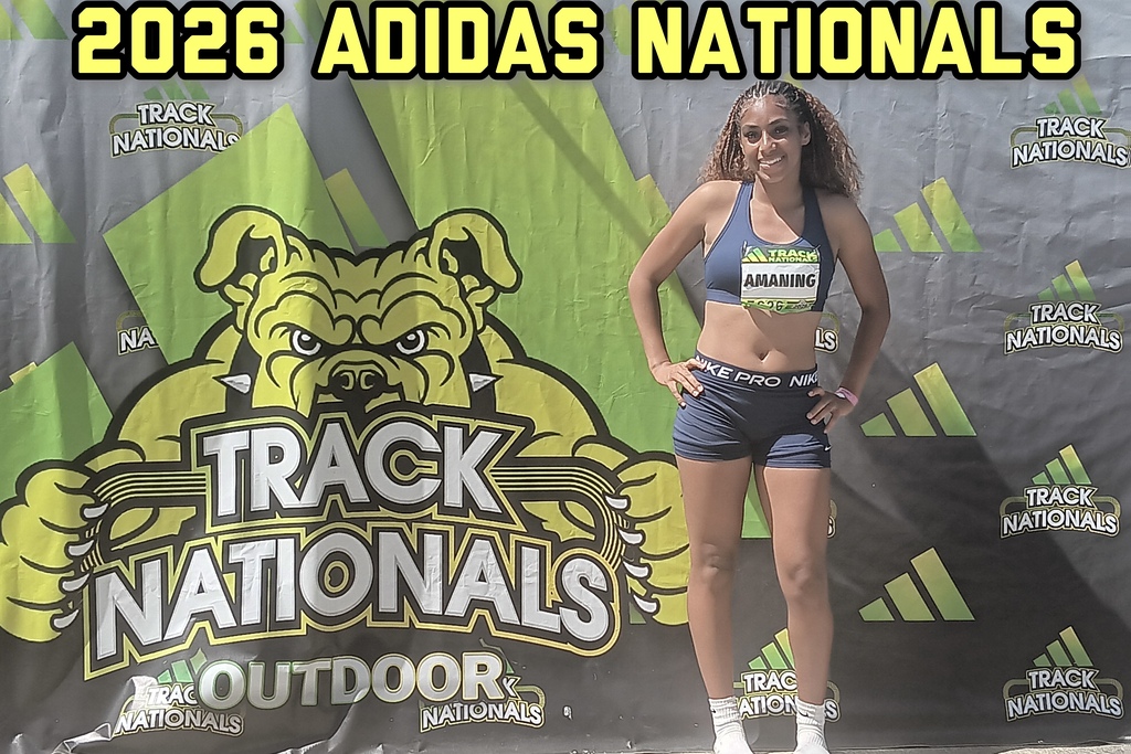 One student athlete stands in front of a backdrop that says Track Nationals Outdoor.