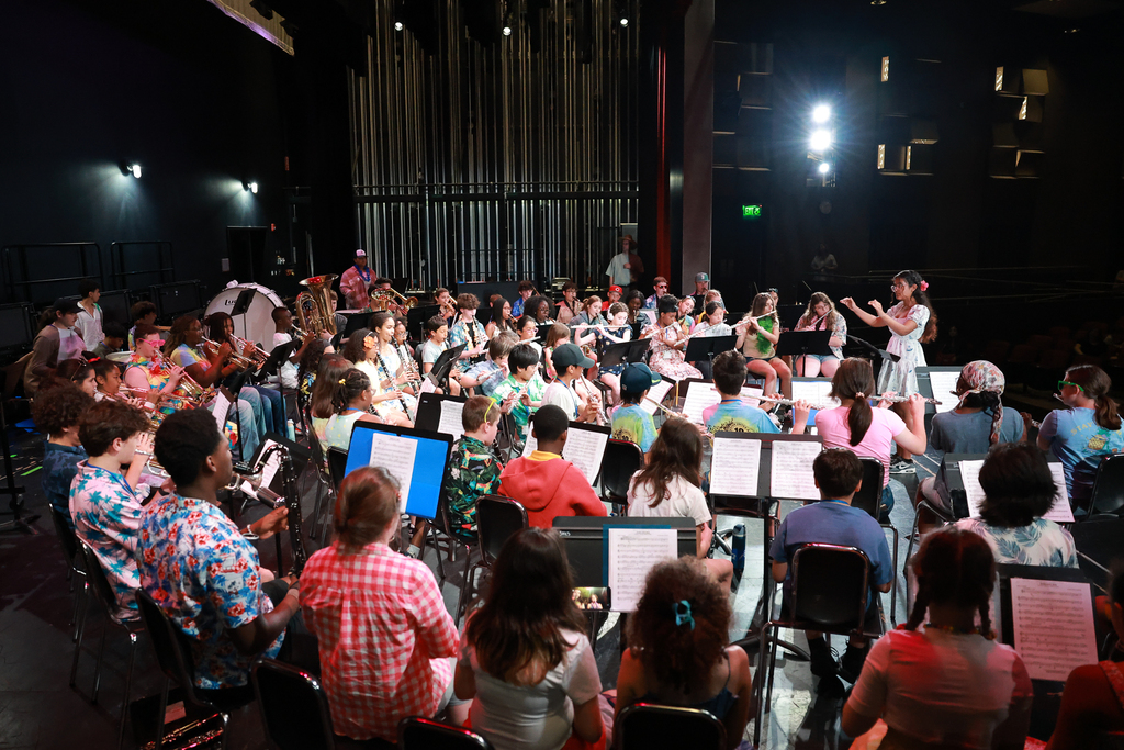 A symphony band plays on stage.