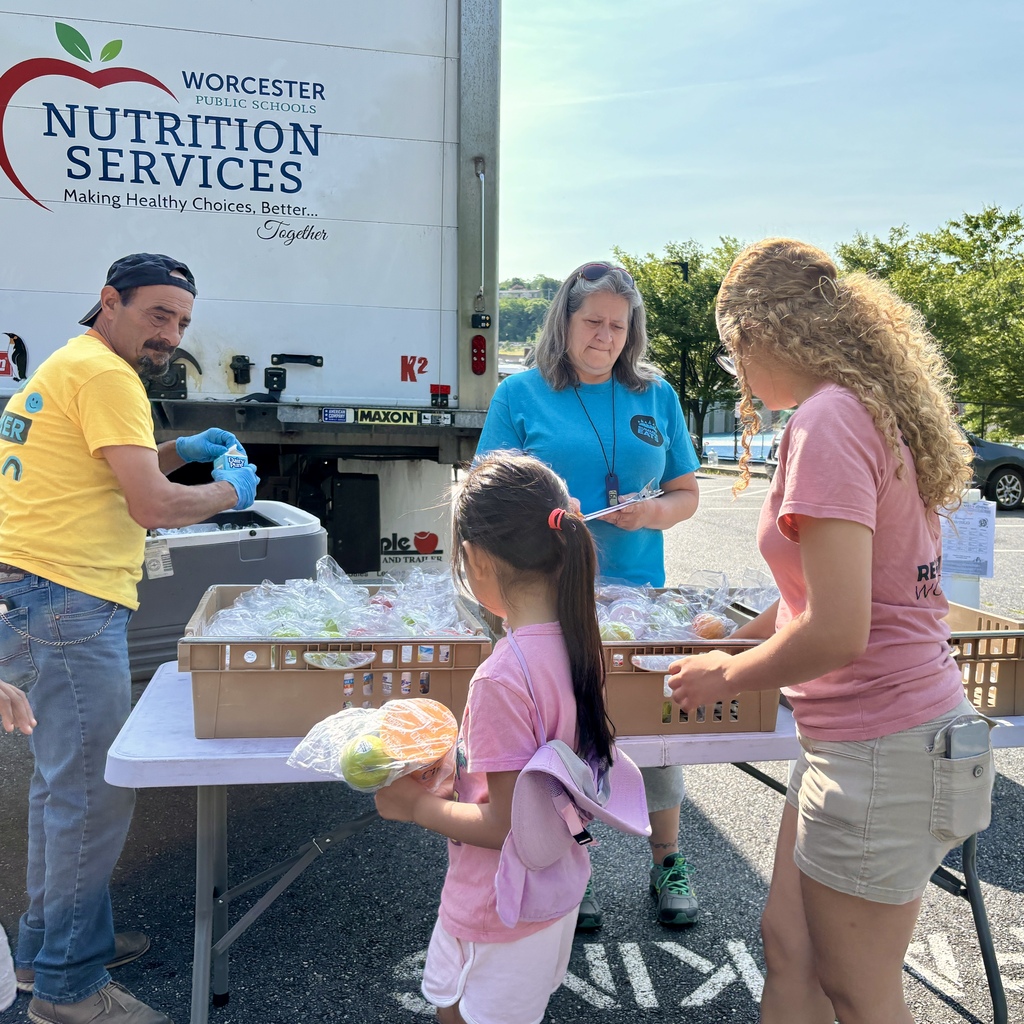Nutrition Services staff distribute pre-packaged meals from a truck labeled “Worcester Public Schools Nutrition Services.”