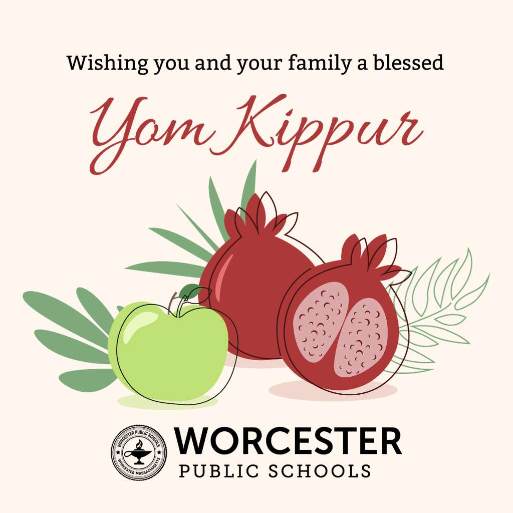 A graphic wishing a blessed Yom Kippur, featuring an apple and pomegranates.