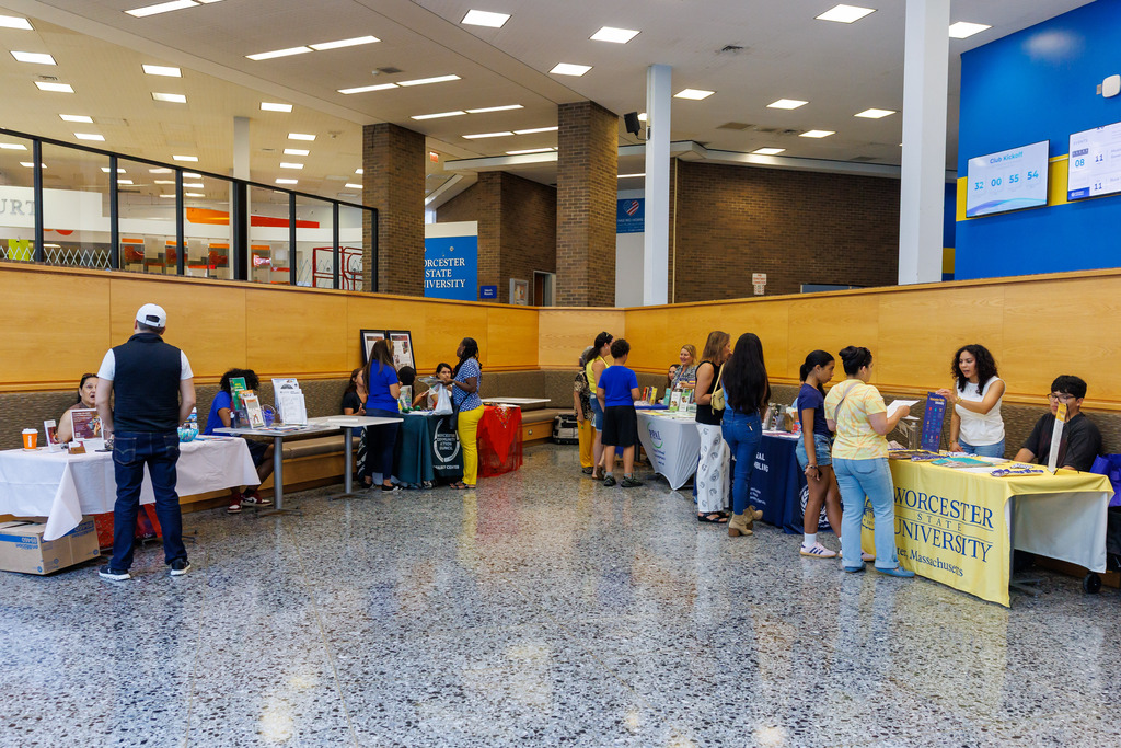 Families and caregivers gather information at resource tables.