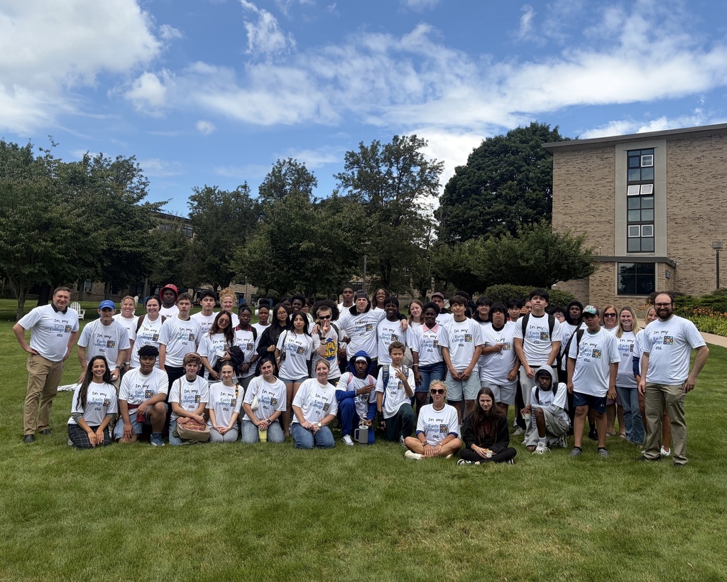 A group of students stand together wearing Early College shirts.