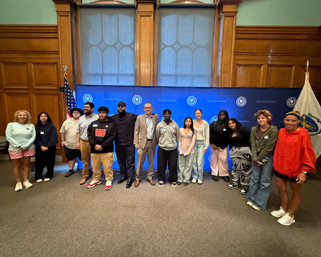 Students stands with local government officials.
