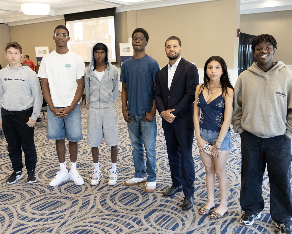 Students stands with local business leaders.