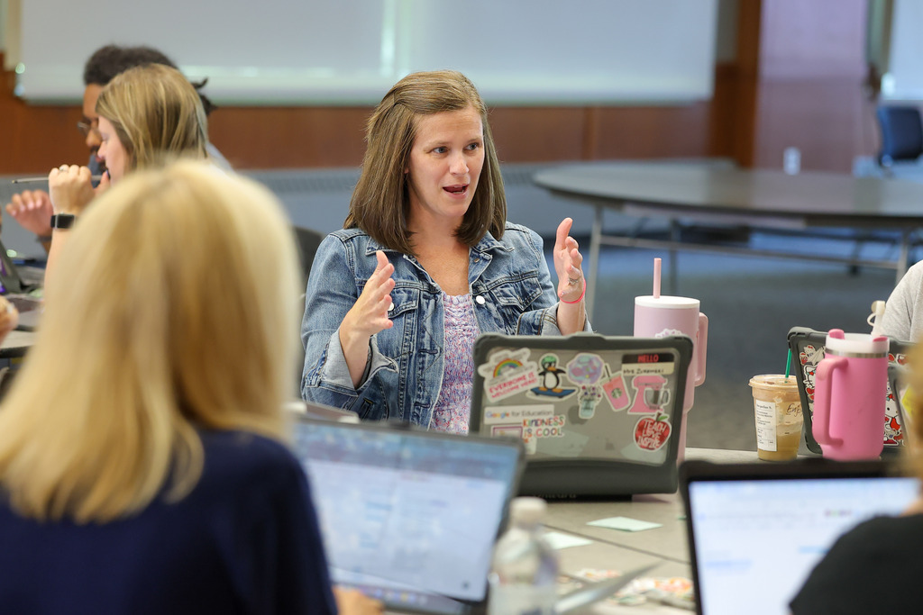 A teacher talks during a group conversation.