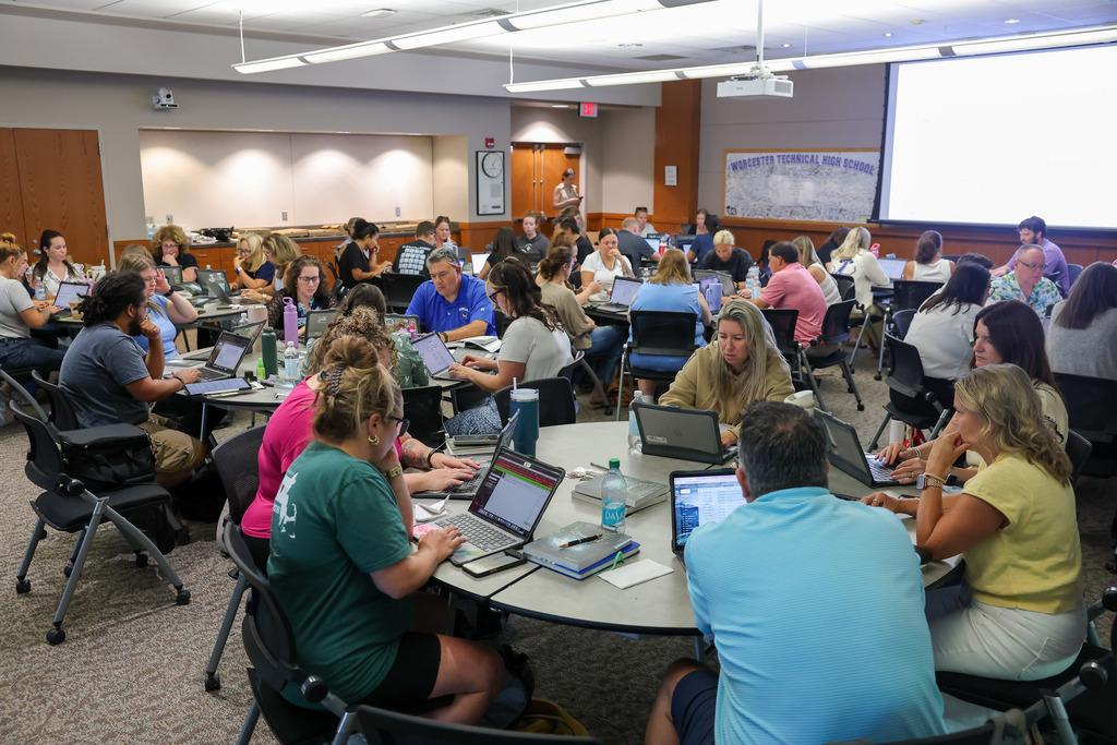 A room full of educators work together.